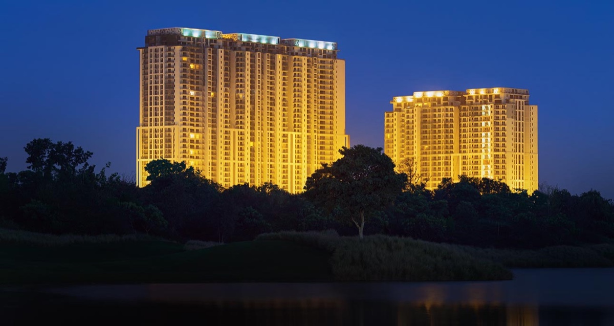The Crest towers lit at night above the golf course (photograph)